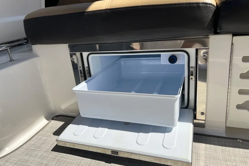 Slide: The Image of 2020 Sea Ray 280 SLX boat interior with open storage compartment under seat. - 50