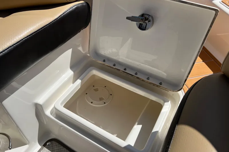 Slide: The Image of Open storage compartment on 2020 Sea Ray 280 SLX boat, featuring beige and black seating. - 52