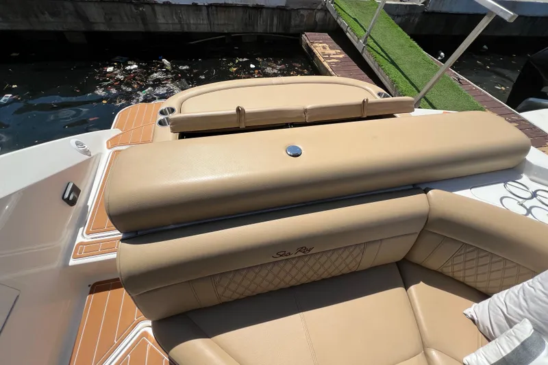 Slide: The Image of 2020 Sea Ray 280 SLX boat with tan leather seating and dockside view. - 6