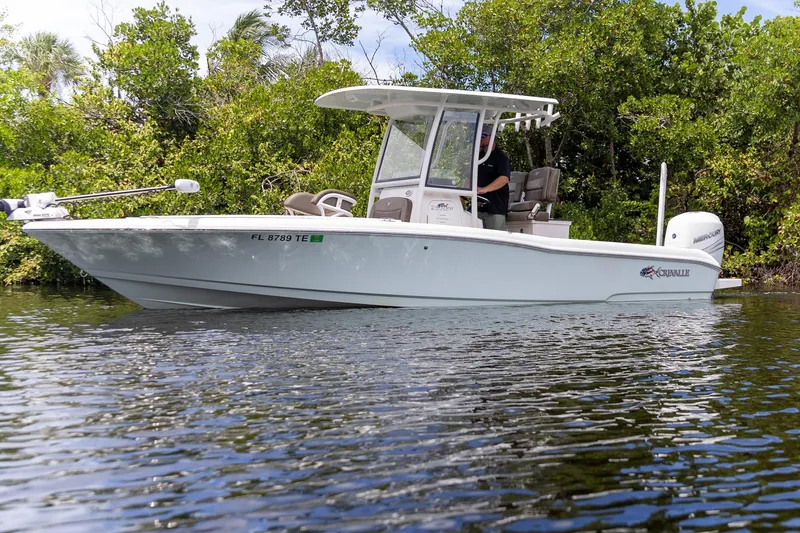The Image of 2022 Crevalle 26 HBW boat on calm water, surrounded by lush greenery. - 0