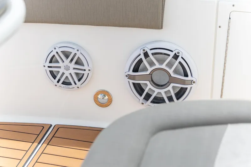 Slide: The Image of Speakers on 2022 Crevalle 26 HBW boat with teak flooring and cushioned seating. - 10