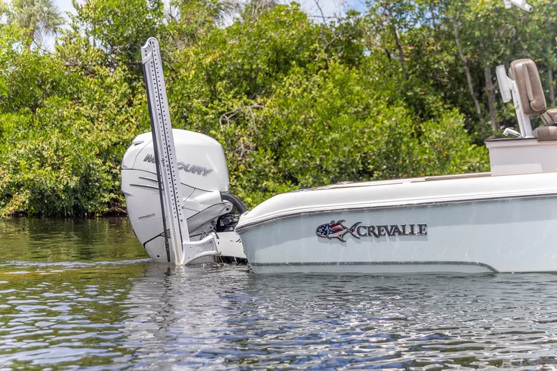 Slide: The Image of 2022 Crevalle 26 HBW boat with Mercury engine in a serene water setting. - 11