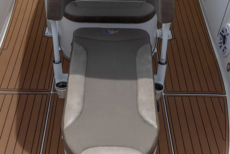 Slide: The Image of 2022 Crevalle 26 HBW boat interior with cushioned seating and teak-style flooring. - 12