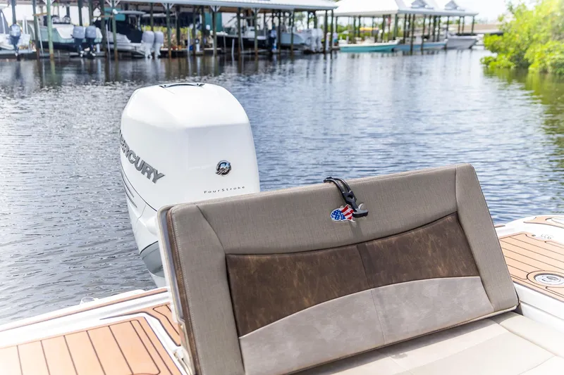 Slide: The Image of 2022 Crevalle 26 HBW boat with Mercury engine, docked on calm water. - 19