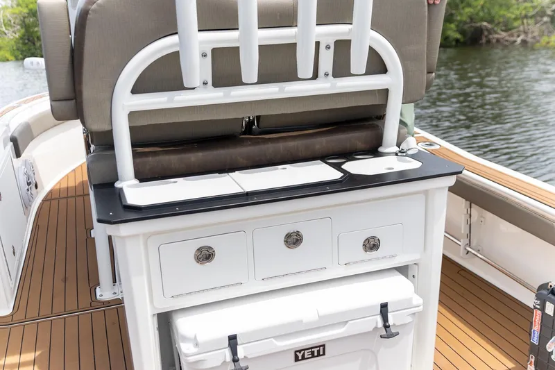 Slide: The Image of 2022 Crevalle 26 HBW boat interior with seating, storage, and Yeti cooler on deck. - 22