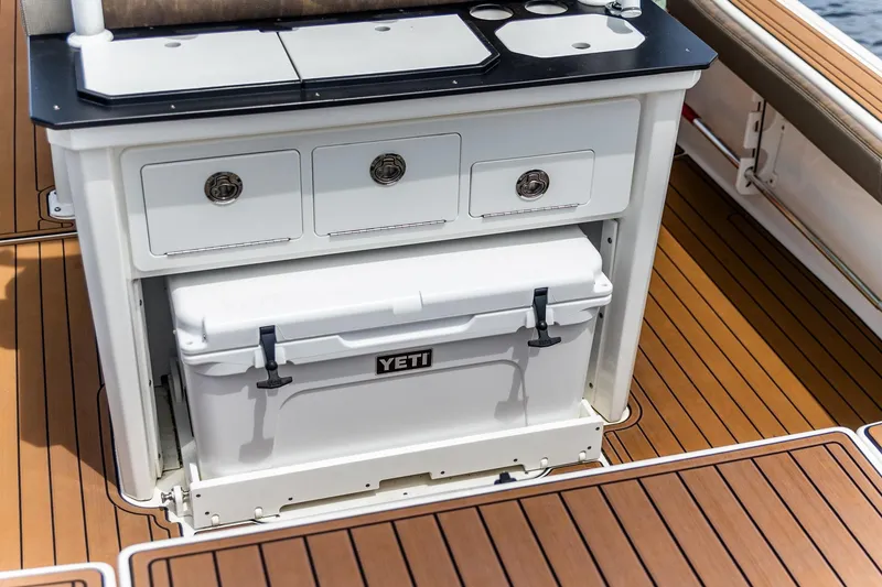 Slide: The Image of 2022 Crevalle 26 HBW boat with Yeti cooler and storage drawers on deck. - 25