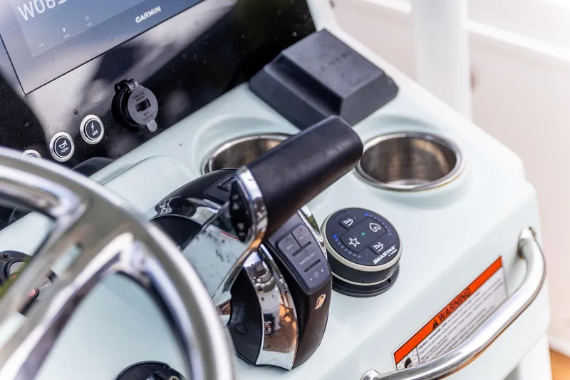 Slide: The Image of Control panel of 2022 Crevalle 26 HBW boat with steering wheel and throttle. - 29