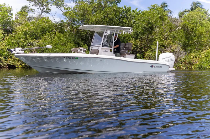 Slide: The Image of 2022 Crevalle 26 HBW boat cruising on a calm river, surrounded by lush greenery. - 34