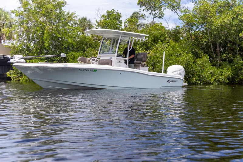 Slide: The Image of 2022 Crevalle 26 HBW boat cruising on a calm river near lush greenery. - 35