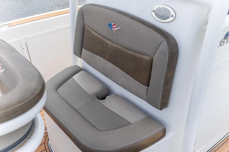 Slide: The Image of Crevalle 26 HBW 2022 boat seat with American flag emblem, gray and brown upholstery. - 4
