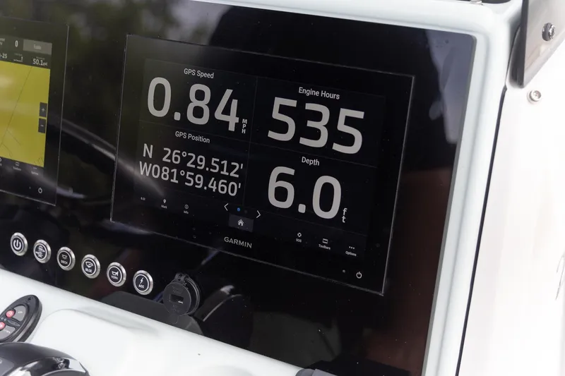 Slide: The Image of Garmin display on 2022 Crevalle 26 HBW showing GPS speed, position, engine hours, and depth. - 6