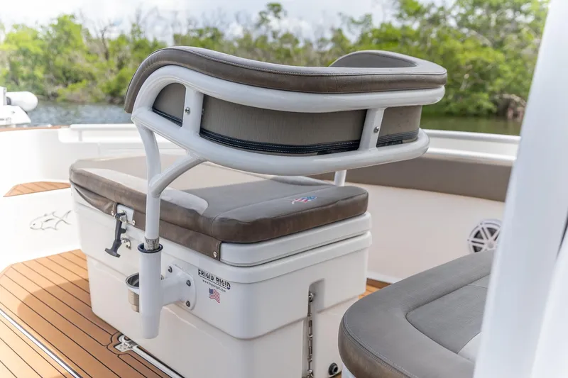 Slide: The Image of 2022 Crevalle 26 HBW boat interior with cushioned seating and storage. - 8