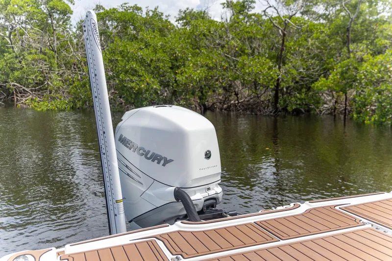 Slide: The Image of 2022 Crevalle 26 HBW boat with Mercury outboard motor in a serene mangrove setting. - 9