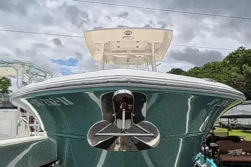 Slide: The Image of 2018 Sea Fox 266 Commander boat with anchor, viewed from the front under cloudy skies. - 2