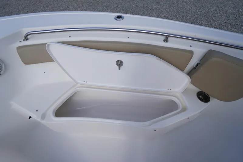 Slide: The Image of 2019 Tidewater 220 LXF boat storage compartment with open hatch and cushioned seating. - 10
