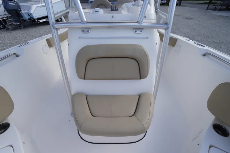 Slide: The Image of 2019 Tidewater 220 LXF boat interior with beige cushioned seating. - 12