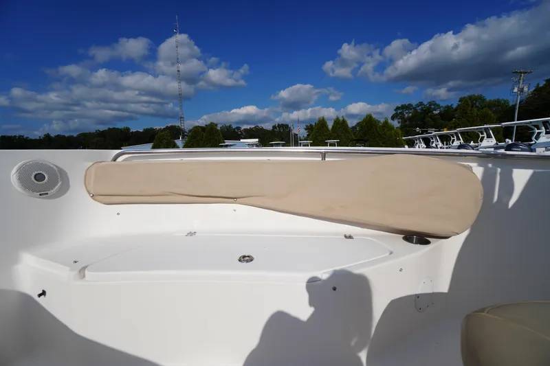Slide: The Image of 2019 Tidewater 220 LXF boat interior with seating and speaker under blue sky. - 15