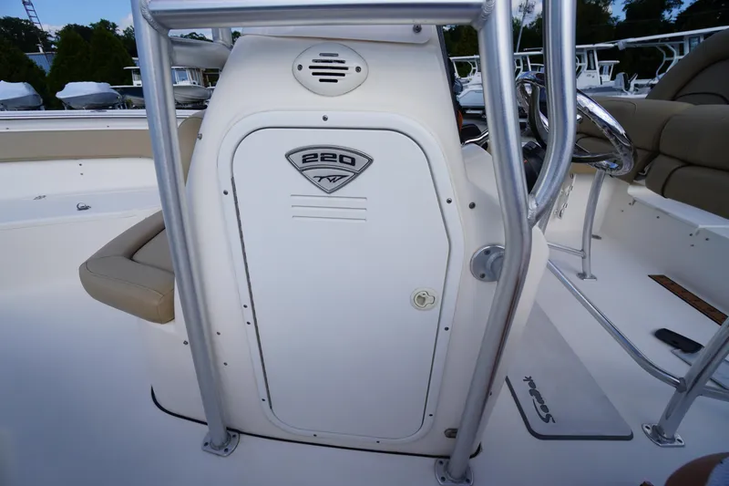 Slide: The Image of 2019 Tidewater 220 LXF boat console with seating and steering wheel. - 16