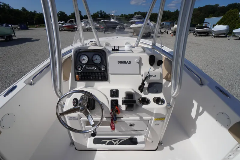 Slide: The Image of 2019 Tidewater 220 LXF boat console with steering wheel and navigation equipment. - 18