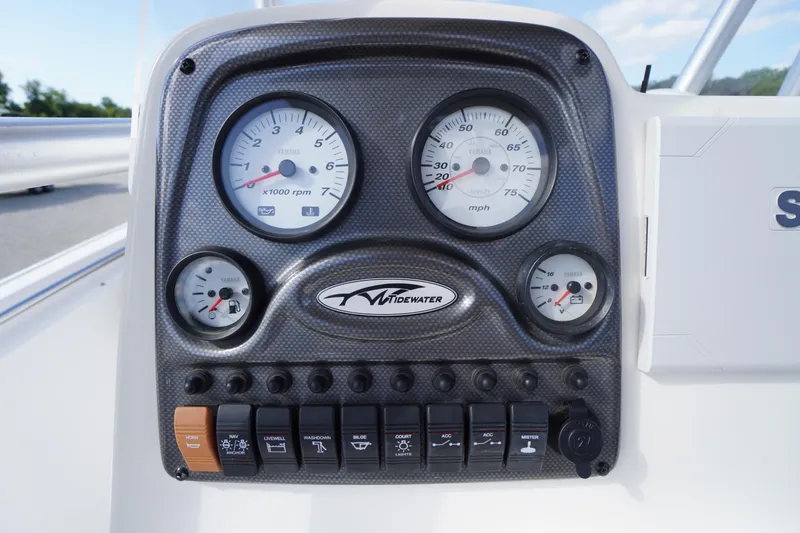 Slide: The Image of 2019 Tidewater 220 LXF dashboard with gauges and control switches. - 19