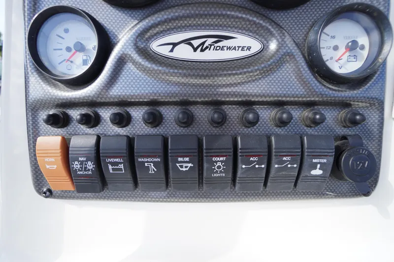 Slide: The Image of Control panel of a 2019 Tidewater 220 LXF boat with various switches and gauges. - 20