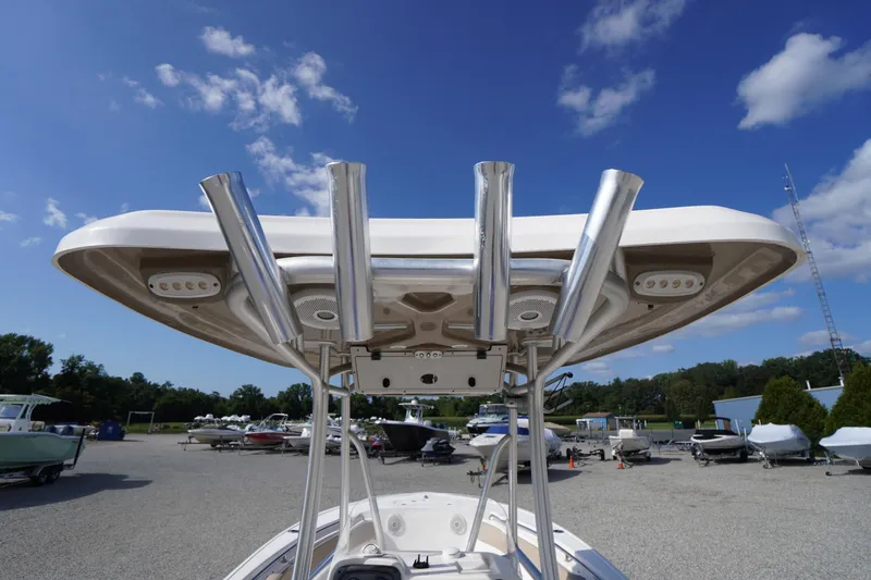 Slide: The Image of 2019 Tidewater 220 LXF boat with T-top and rod holders under a clear blue sky. - 29