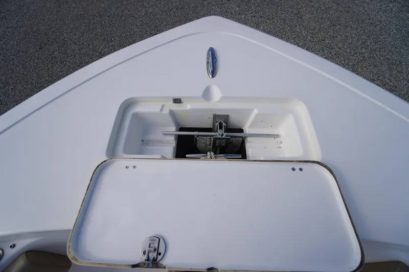 Slide: The Image of 2019 Tidewater 220 LXF boat anchor compartment, open lid, white deck. - 3