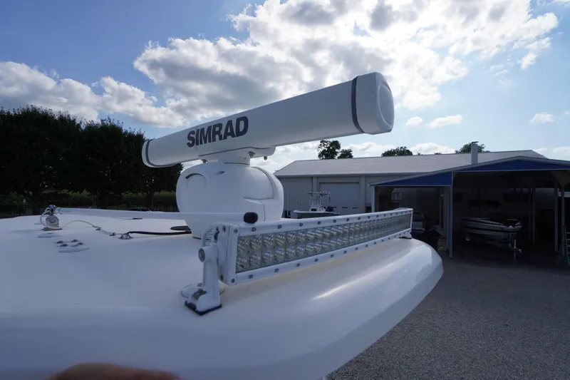 Slide: The Image of 2019 Tidewater 220 LXF boat with Simrad radar and LED light bar under a cloudy sky. - 33