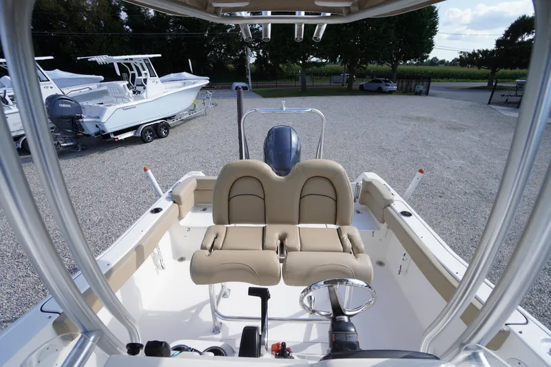 Slide: The Image of 2019 Tidewater 220 LXF boat interior with dual beige seats and steering wheel. - 34