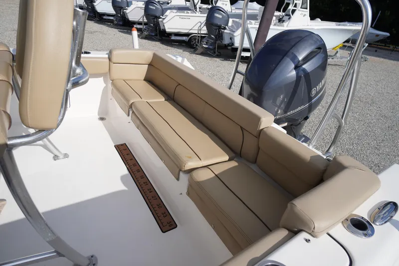 Slide: The Image of 2019 Tidewater 220 LXF boat interior with beige seating and Yamaha outboard motor. - 39