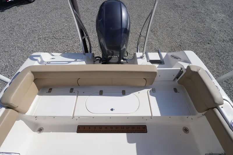 Slide: The Image of 2019 Tidewater 220 LXF boat interior with seating and outboard motor. - 42