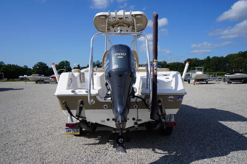 Slide: The Image of 2019 Tidewater 220 LXF boat with outboard motor, parked on gravel lot. - 45