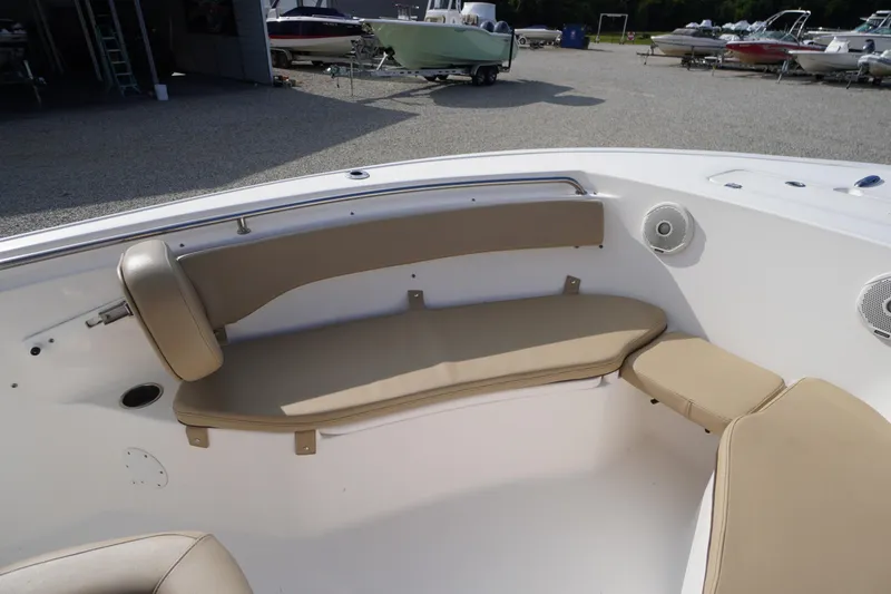 Slide: The Image of 2019 Tidewater 220 LXF boat interior with beige seating and speakers. - 5