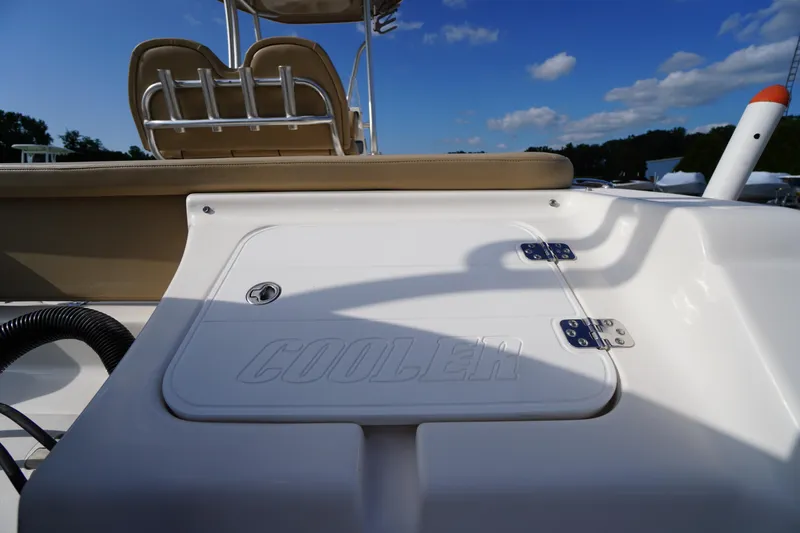 Slide: The Image of 2019 Tidewater 220 LXF boat cooler compartment under clear blue sky. - 50