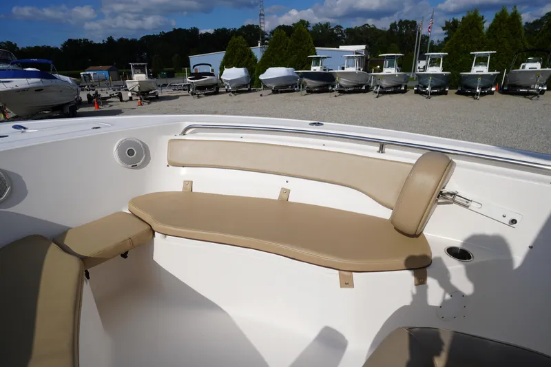 Slide: The Image of 2019 Tidewater 220 LXF boat interior with beige seating and outdoor showroom. - 6