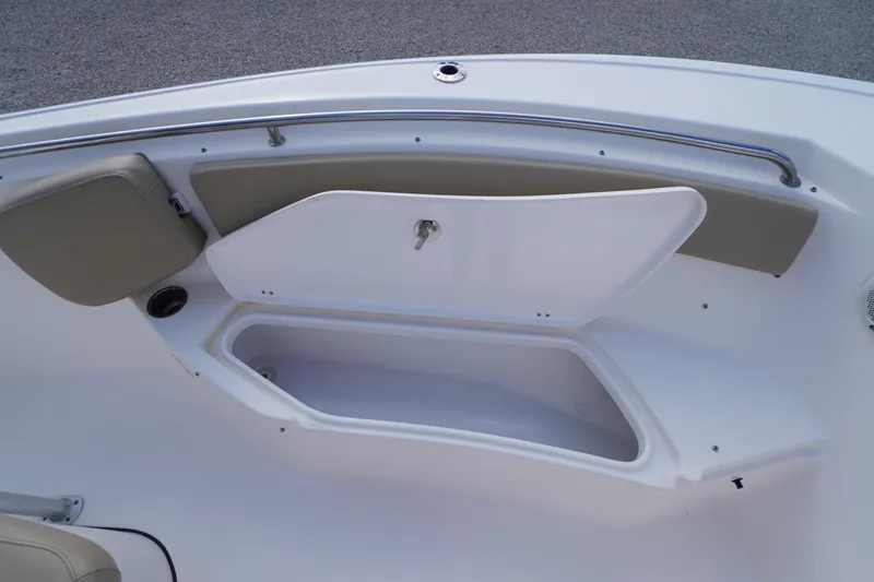 Slide: The Image of 2019 Tidewater 220 LXF boat storage compartment with open hatch and cushioned seating. - 9