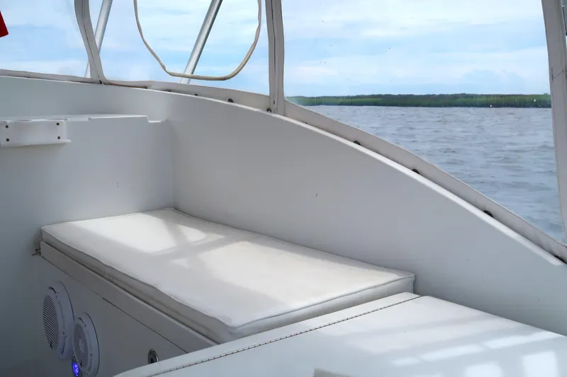 Slide: The Image of Interior view of 1997 Luhrs Tournament 290 boat with cushioned seating and water backdrop. - 10