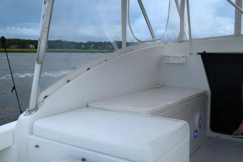 Slide: The Image of 1997 Luhrs Tournament 290 boat interior with cushioned seating and water view. - 11