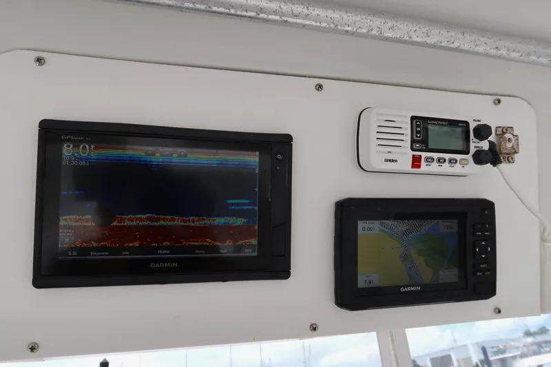 Slide: The Image of 1997 Luhrs Tournament 290 boat dashboard with Garmin navigation and communication devices. - 14