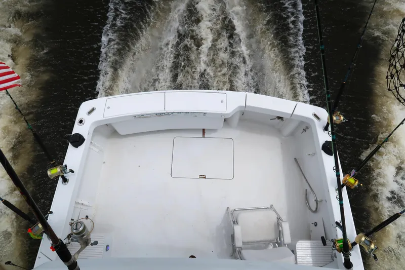 Slide: The Image of 1997 Luhrs Tournament 290 boat deck with fishing rods and American flag. - 4