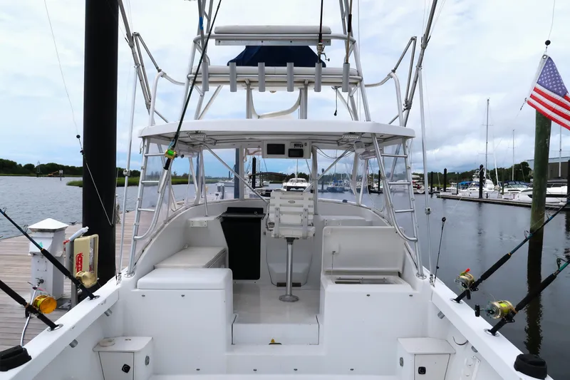 Slide: The Image of 1997 Luhrs Tournament 290 boat docked, featuring fishing rods and American flag. - 7