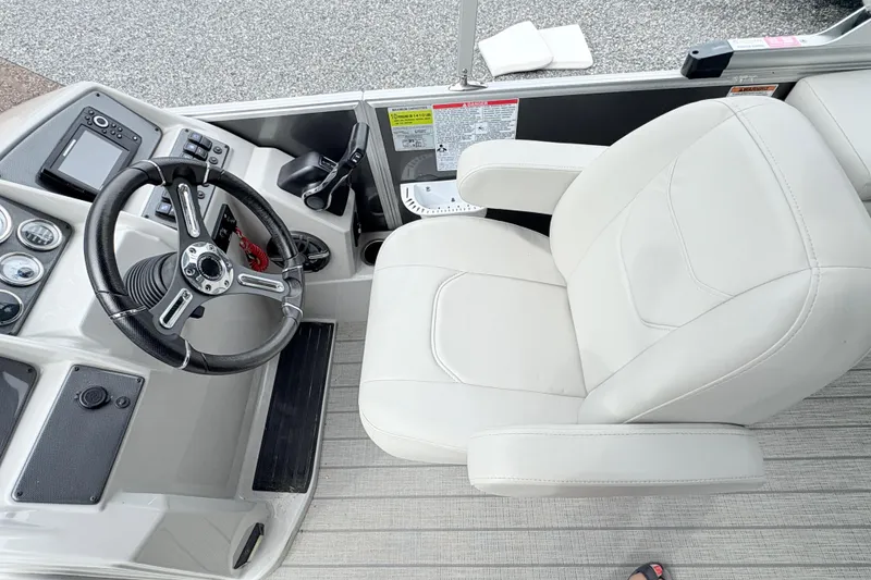 Slide: The Image of 2024 Starcraft 20 EX QDH boat control panel with throttle, speaker, and capacity label. - 11