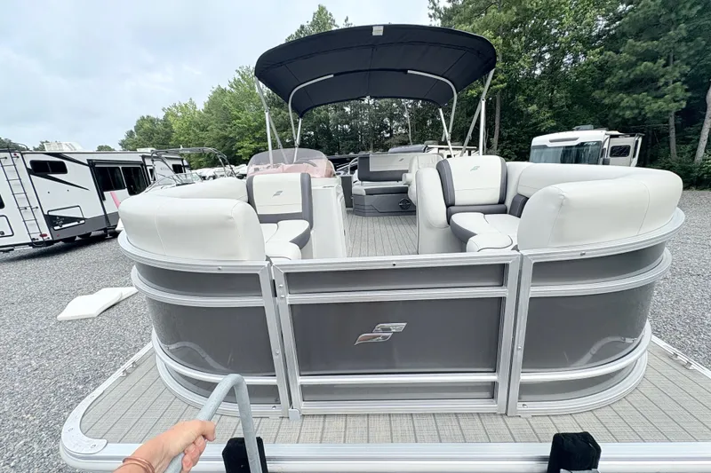 Slide: The Image of 2024 Starcraft 20 EX QDH pontoon boat on trailer in outdoor lot. - 16