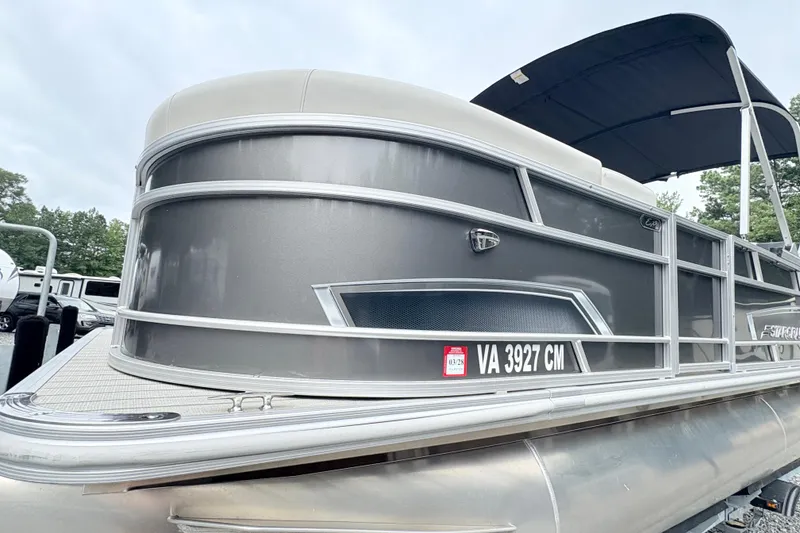 Slide: The Image of 2024 Starcraft 20 EX QDH pontoon boat with Suzuki outboard motor and canopy. - 4