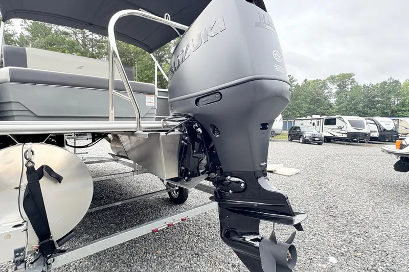 Slide: The Image of 2024 Starcraft 20 EX QDH boat with Suzuki outboard motor in a gravel lot. - 6