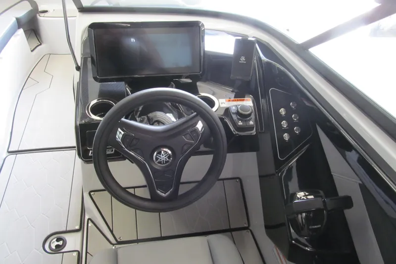 Slide: The Image of 2025 Yamaha Boats 255XD helm with steering wheel, touchscreen, and control panel. - 6