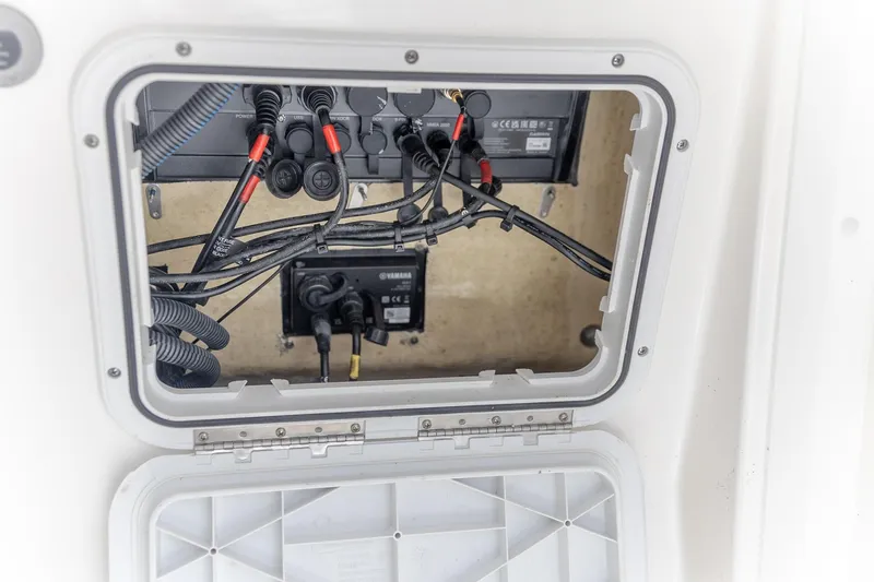 Slide: The Image of 2023 Edgewater 262CC boat wiring compartment with cables and connectors. - 20