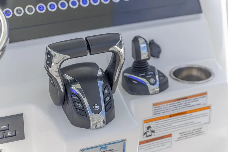Slide: The Image of 2023 Edgewater 262CC boat controls with advanced throttle and joystick system. - 21