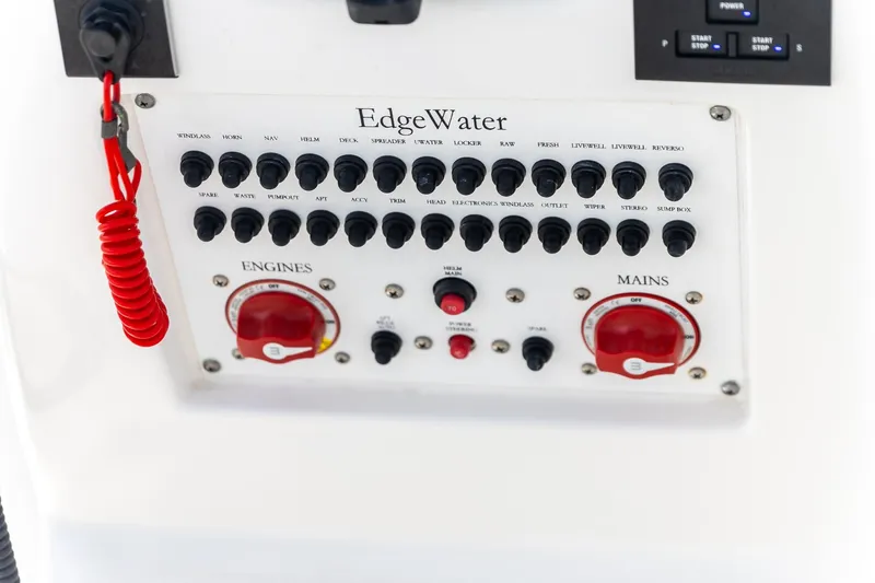 Slide: The Image of Control panel of 2023 Edgewater 262CC boat with switches and red safety cord. - 22