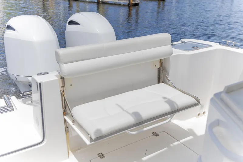 Slide: The Image of 2023 Edgewater 262CC boat with dual engines and a foldable rear seat. - 5